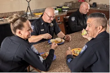 Officers enjoying a meal and conversation around a table